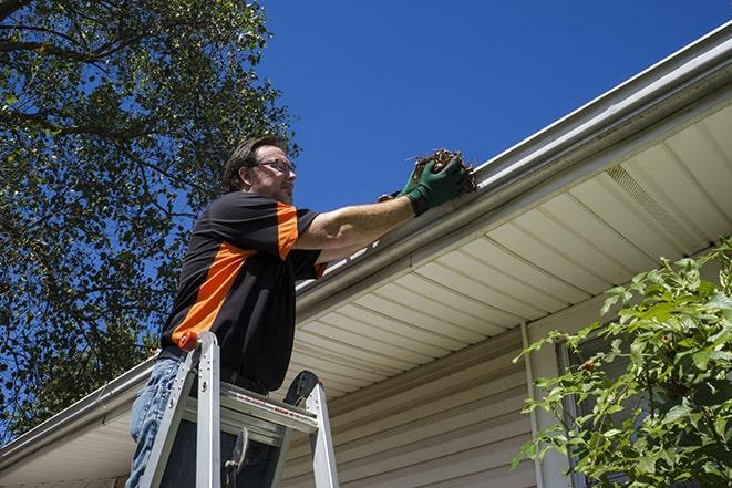 roofing technician replacing a rusted and leaking gutter in Corryton